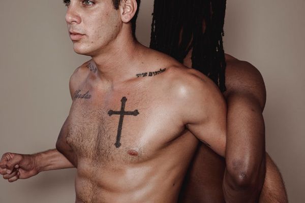 Man performing a controlled bodyweight exercise in a minimalist gym.